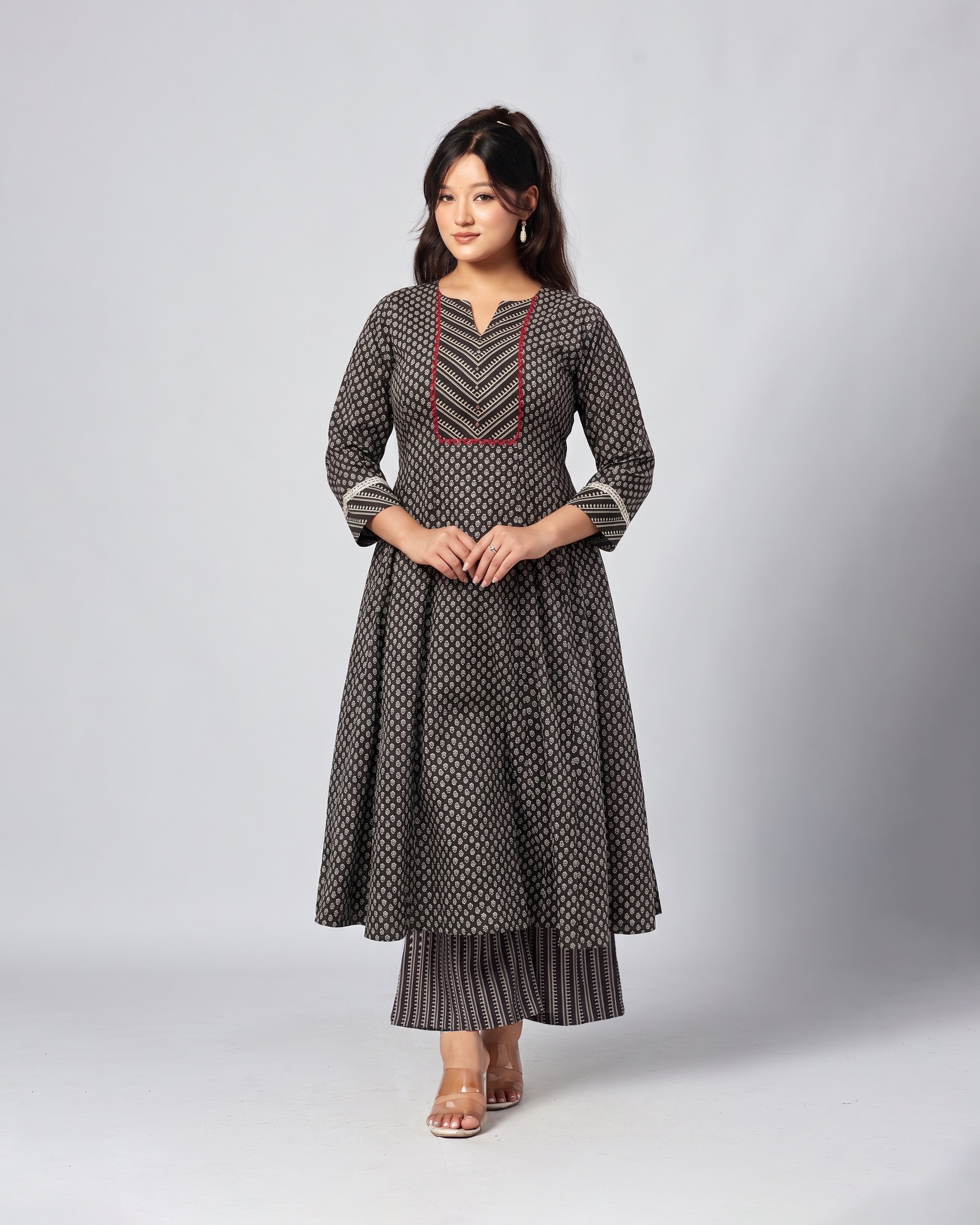 Woman wearing a patterned dress on a Grey background