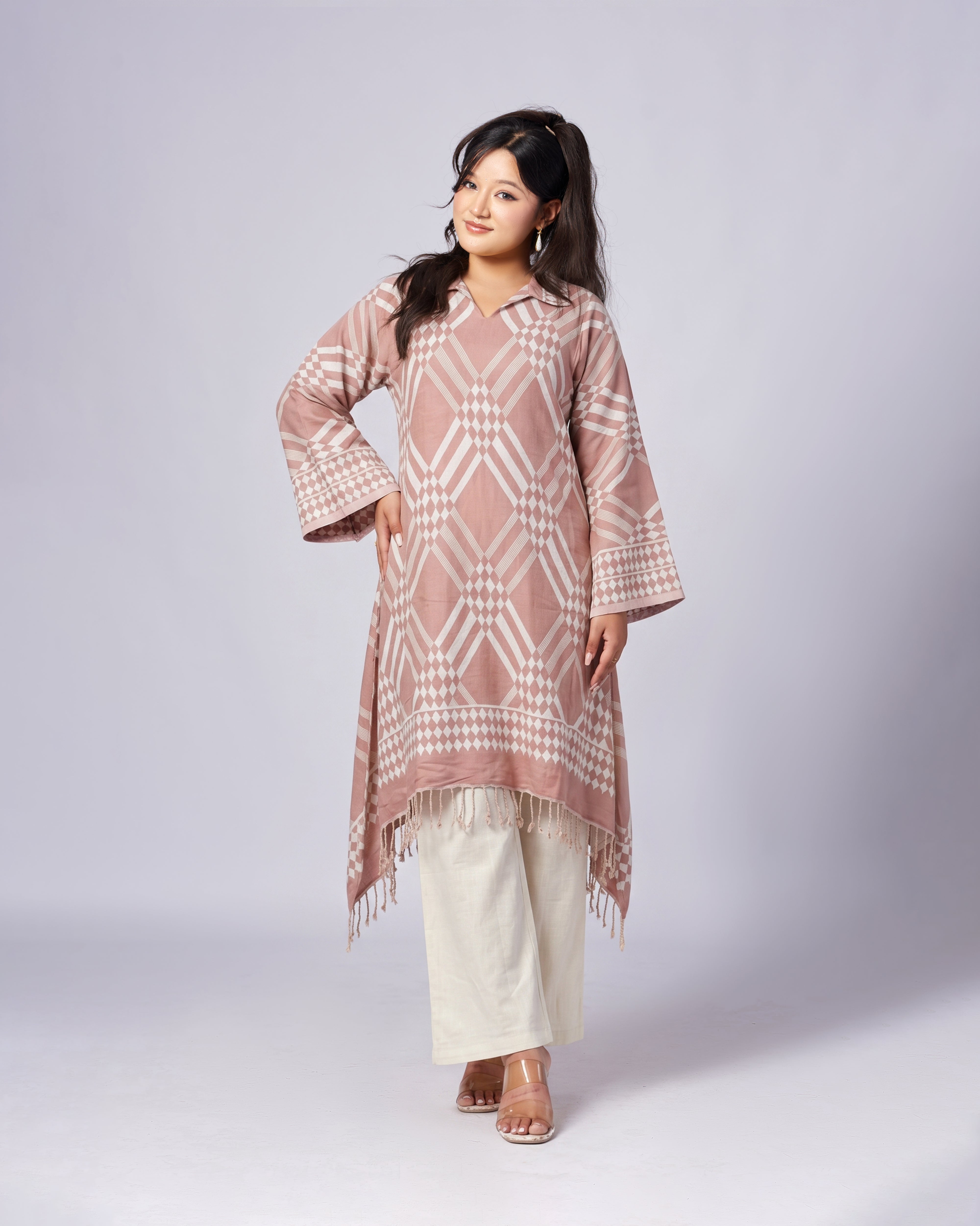 Woman wearing a patterned pink and white outfit on a white background