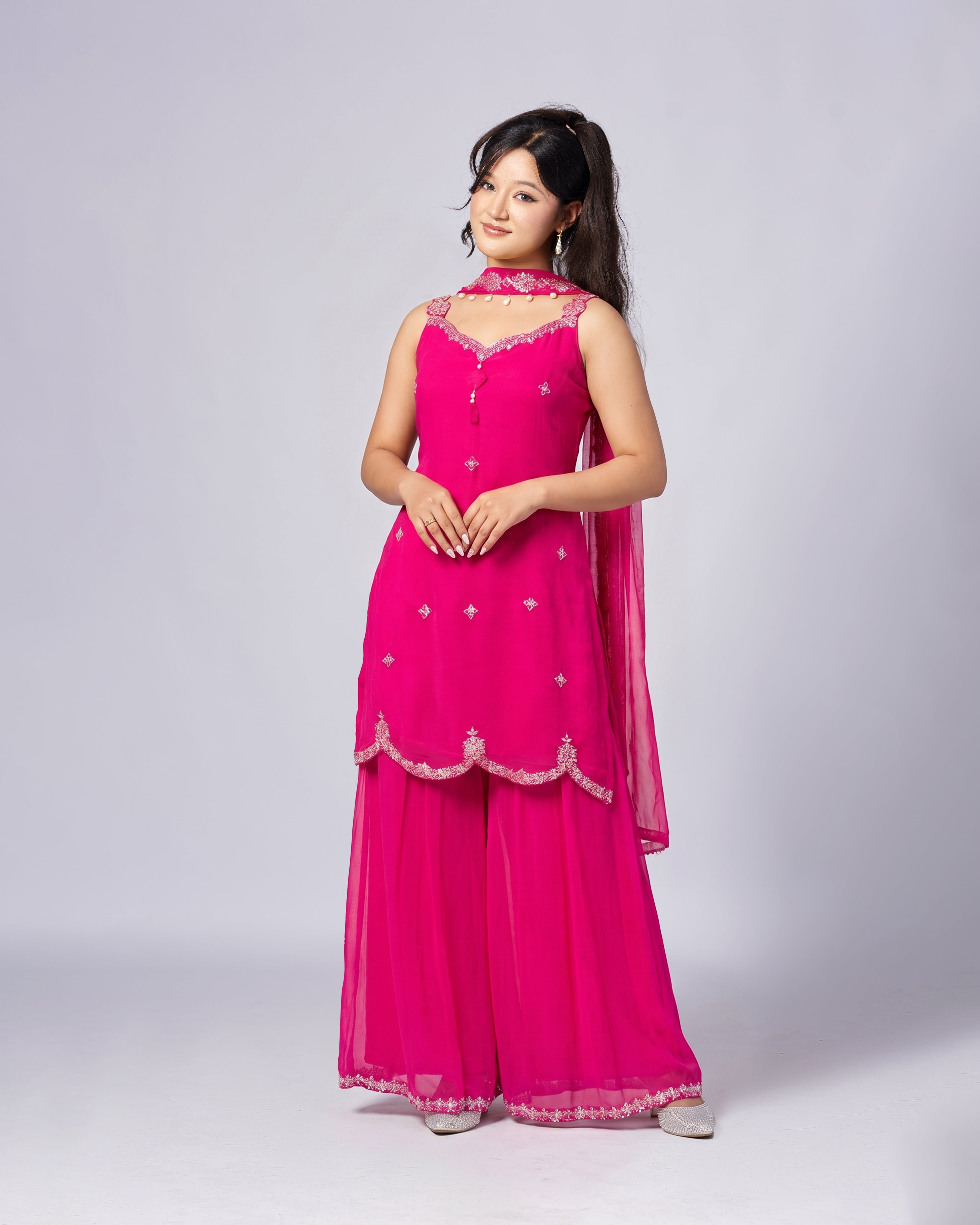 Woman wearing a pink traditional outfit with a white background