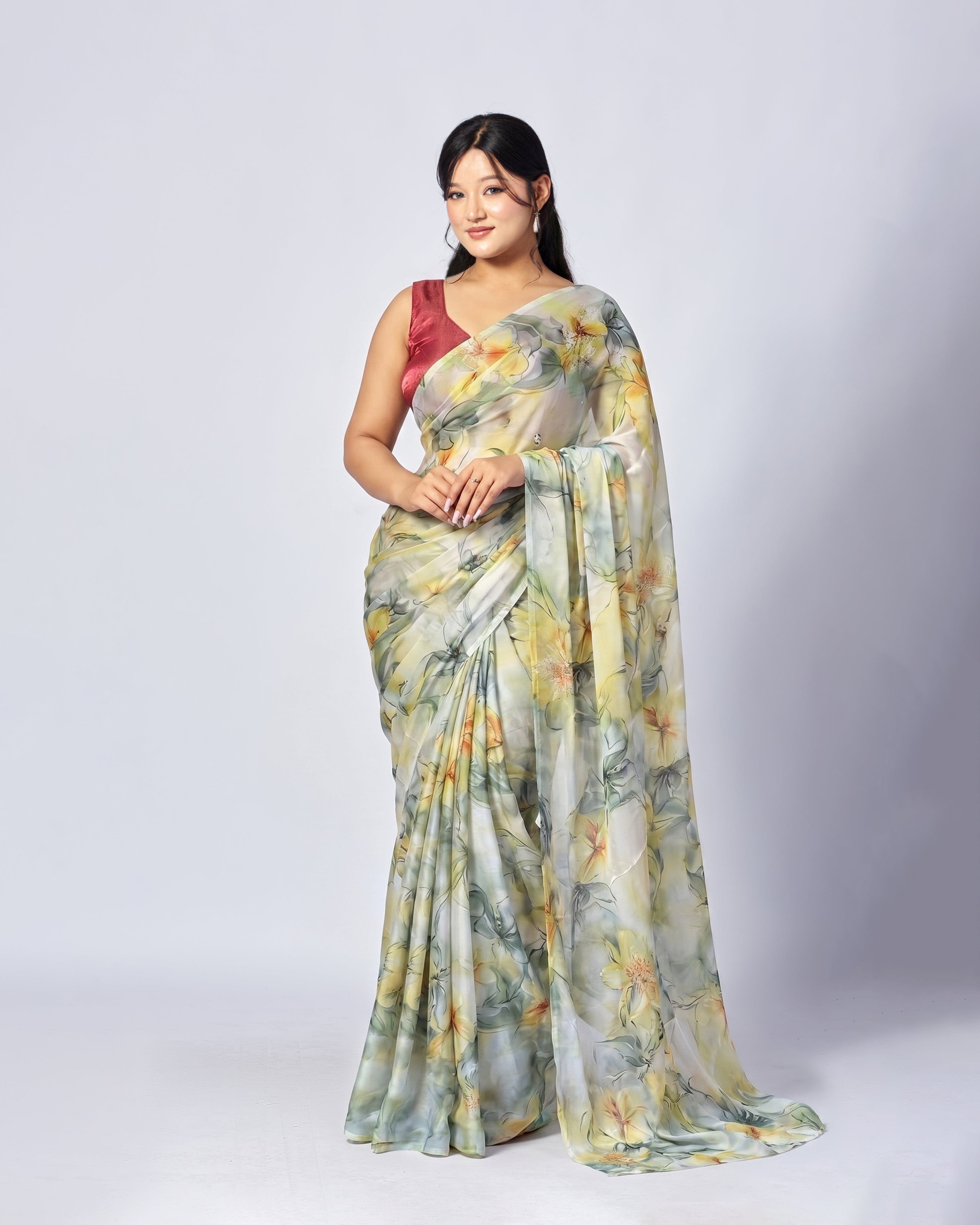 Woman wearing a floral saree with a plain background