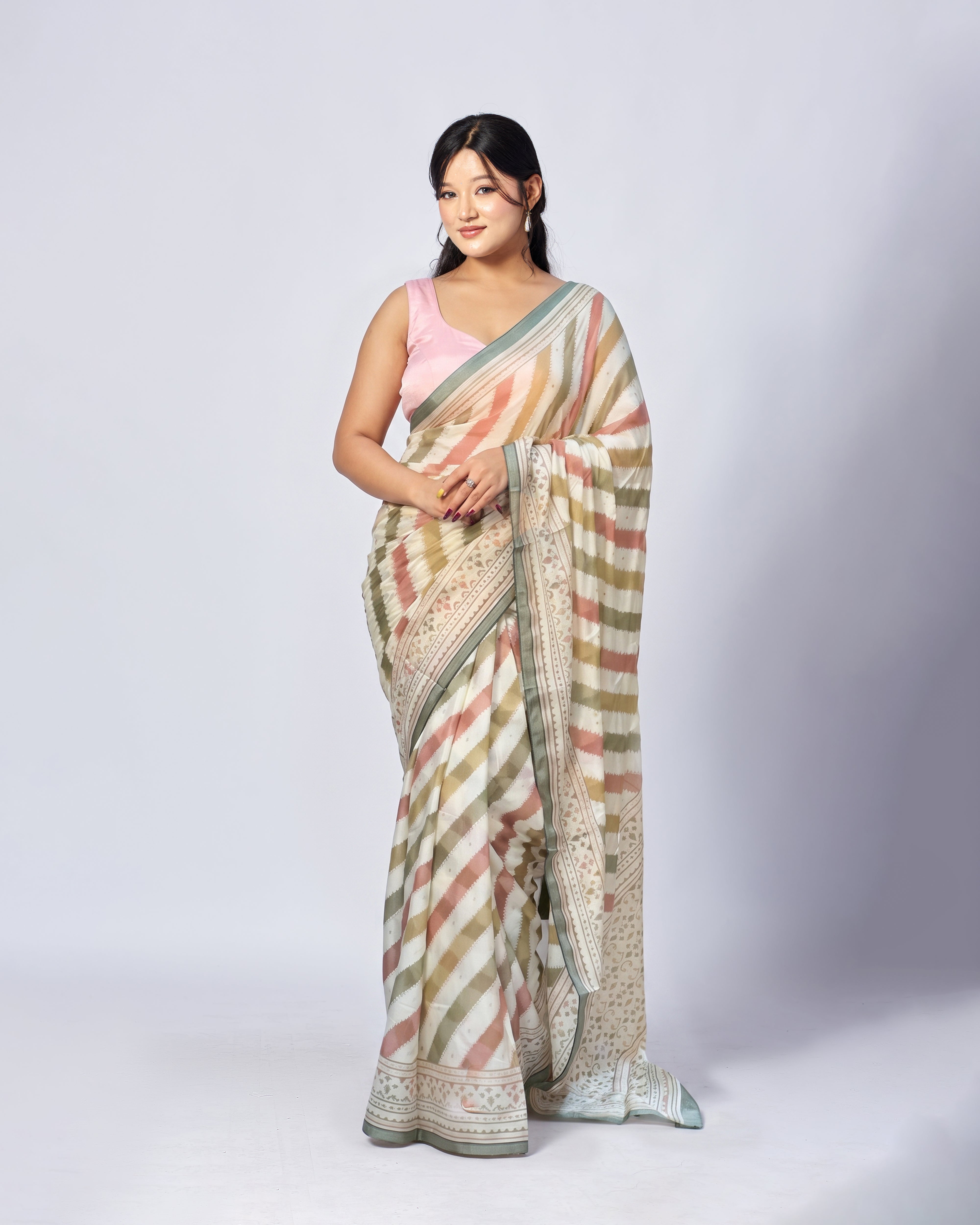 Woman wearing a patterned saree on a white background