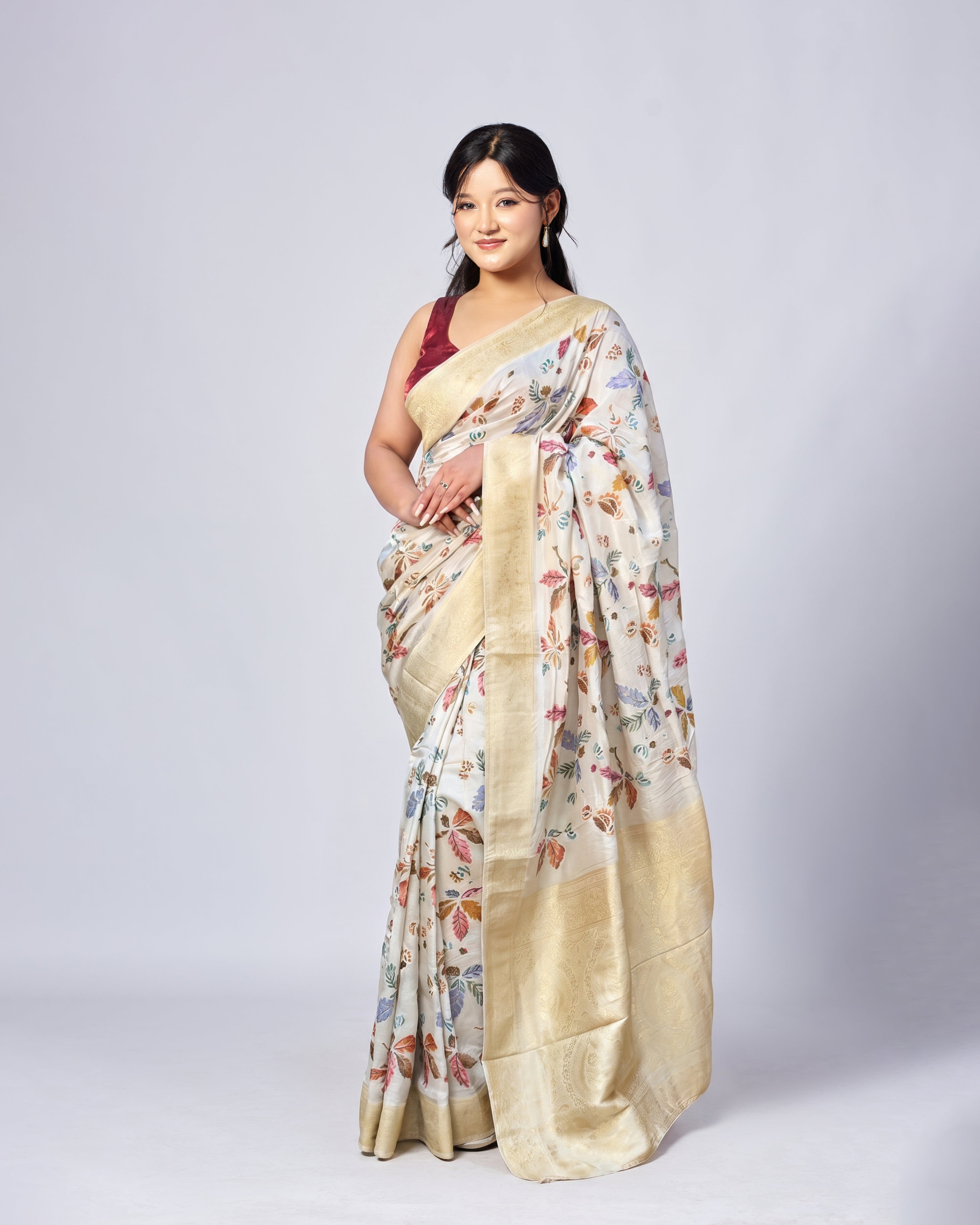Woman wearing a floral saree on a white background