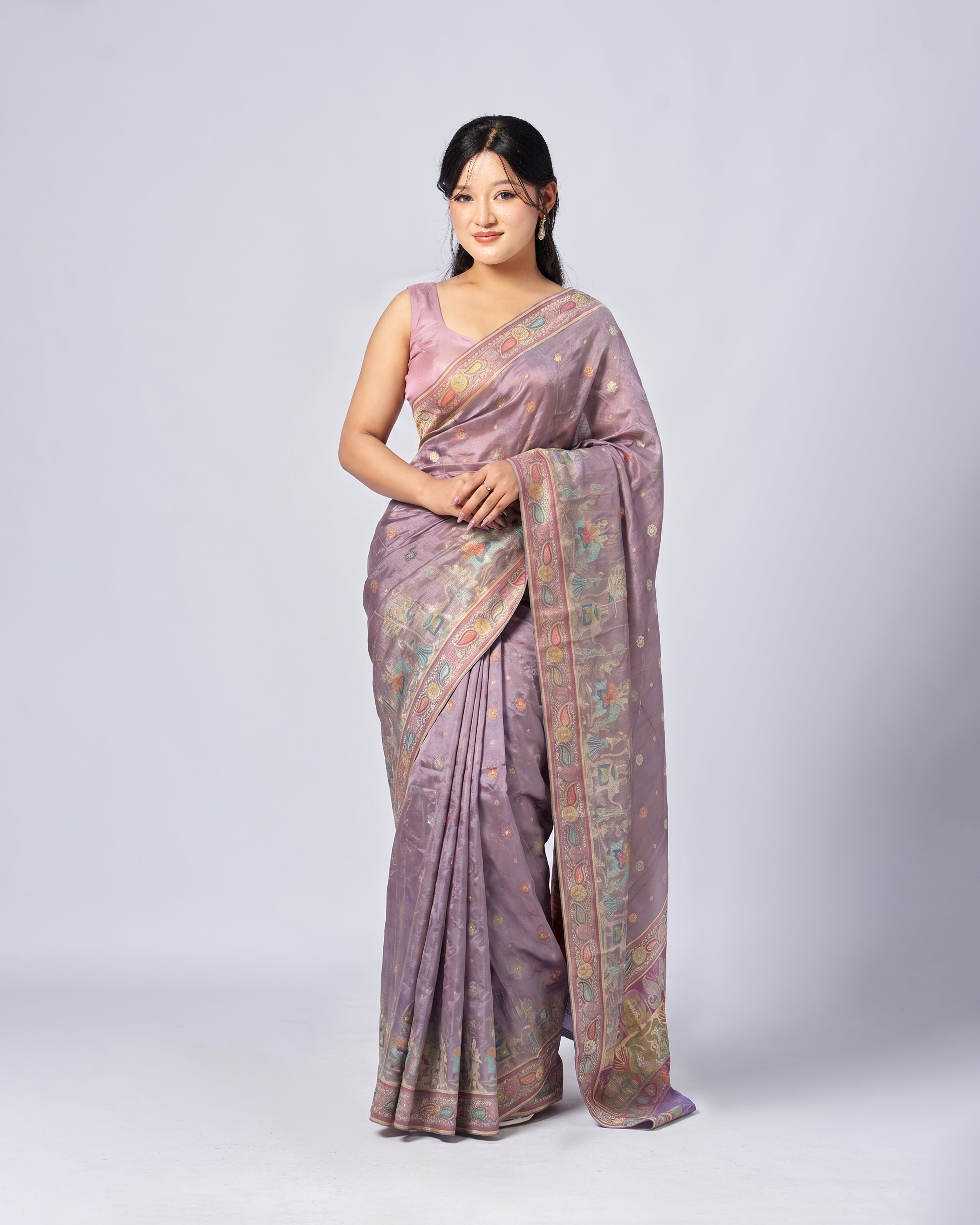 Woman wearing a traditional saree with a white background