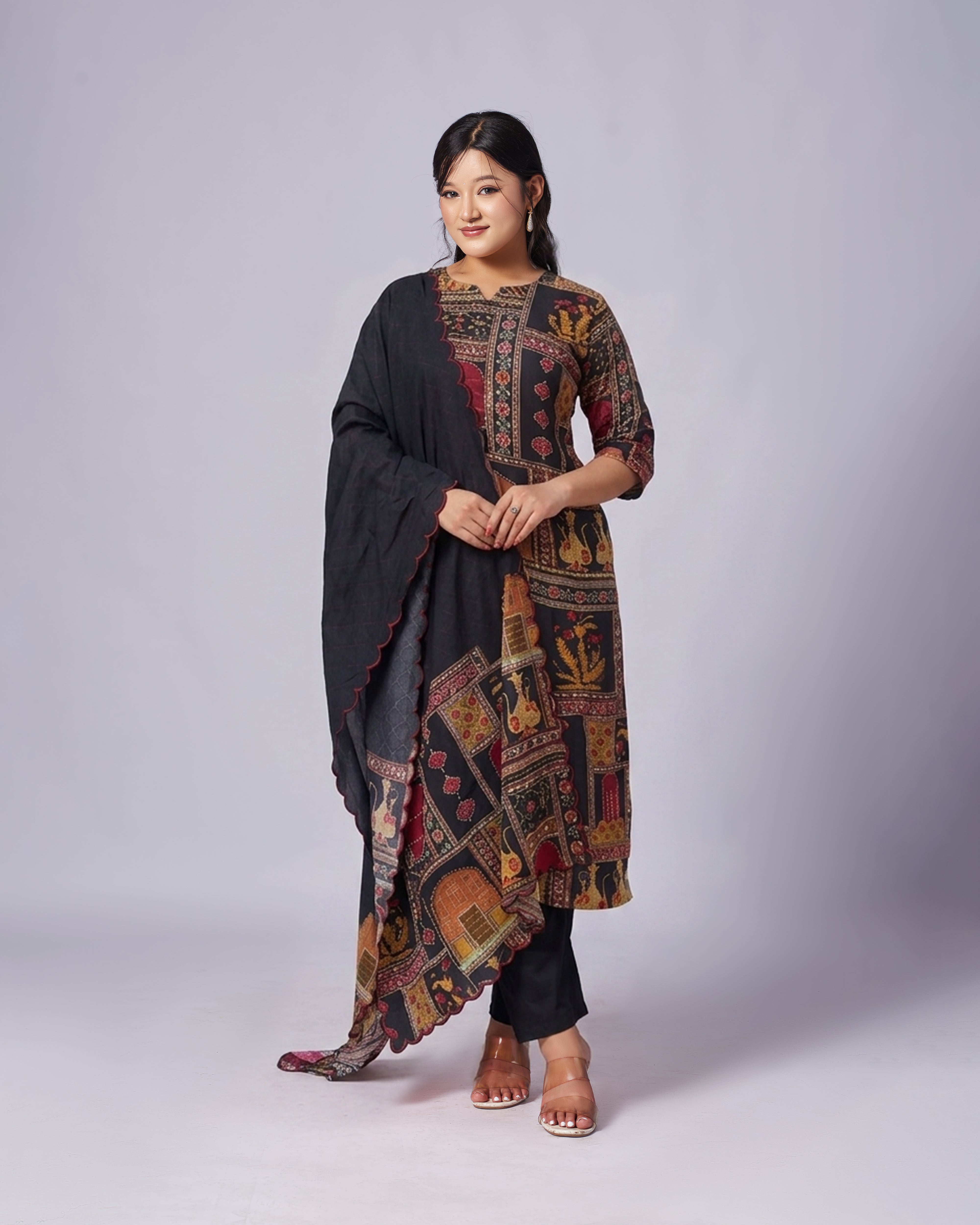 Woman wearing a patterned dress with a plain background