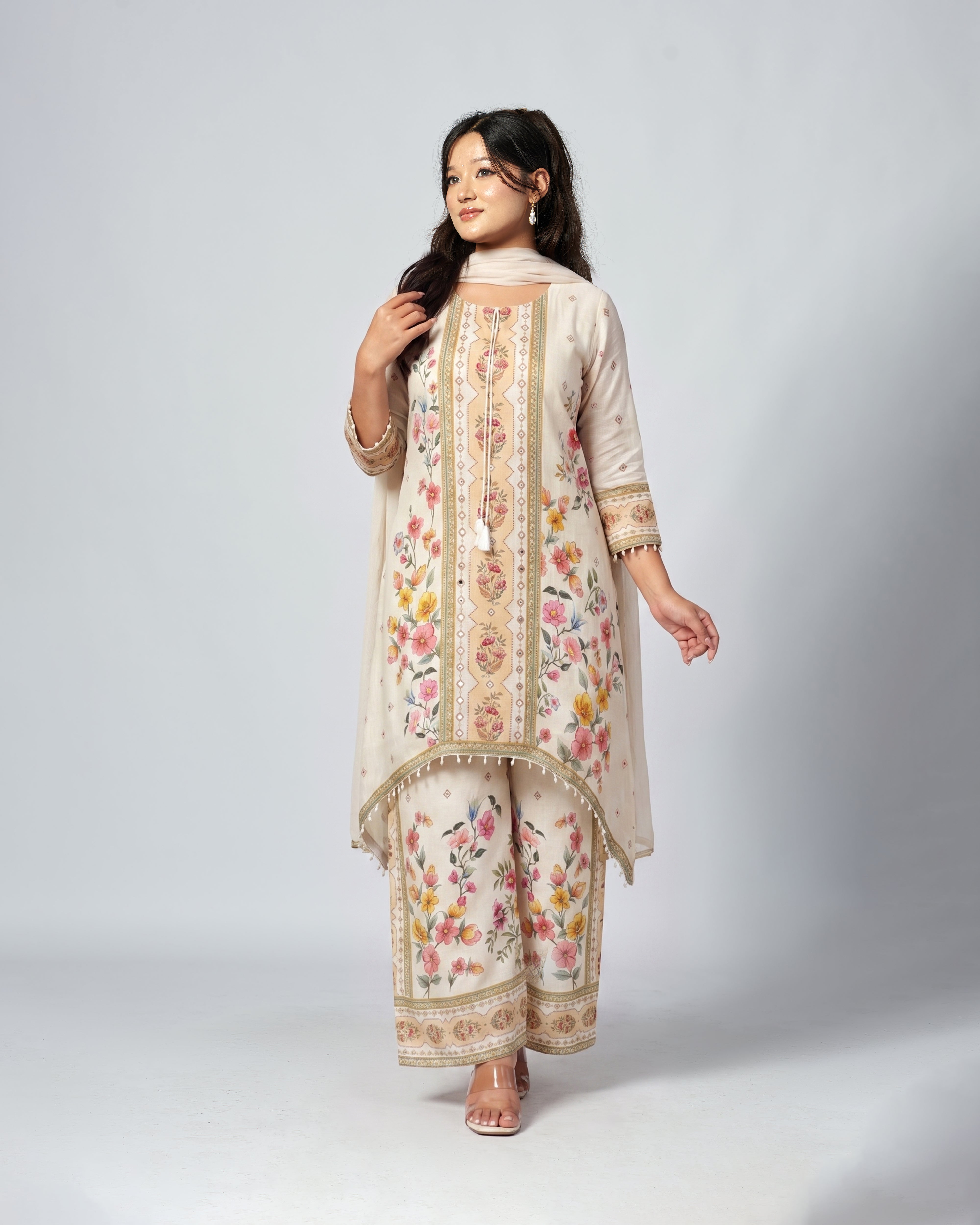 Woman wearing a floral embroidered outfit on a white background