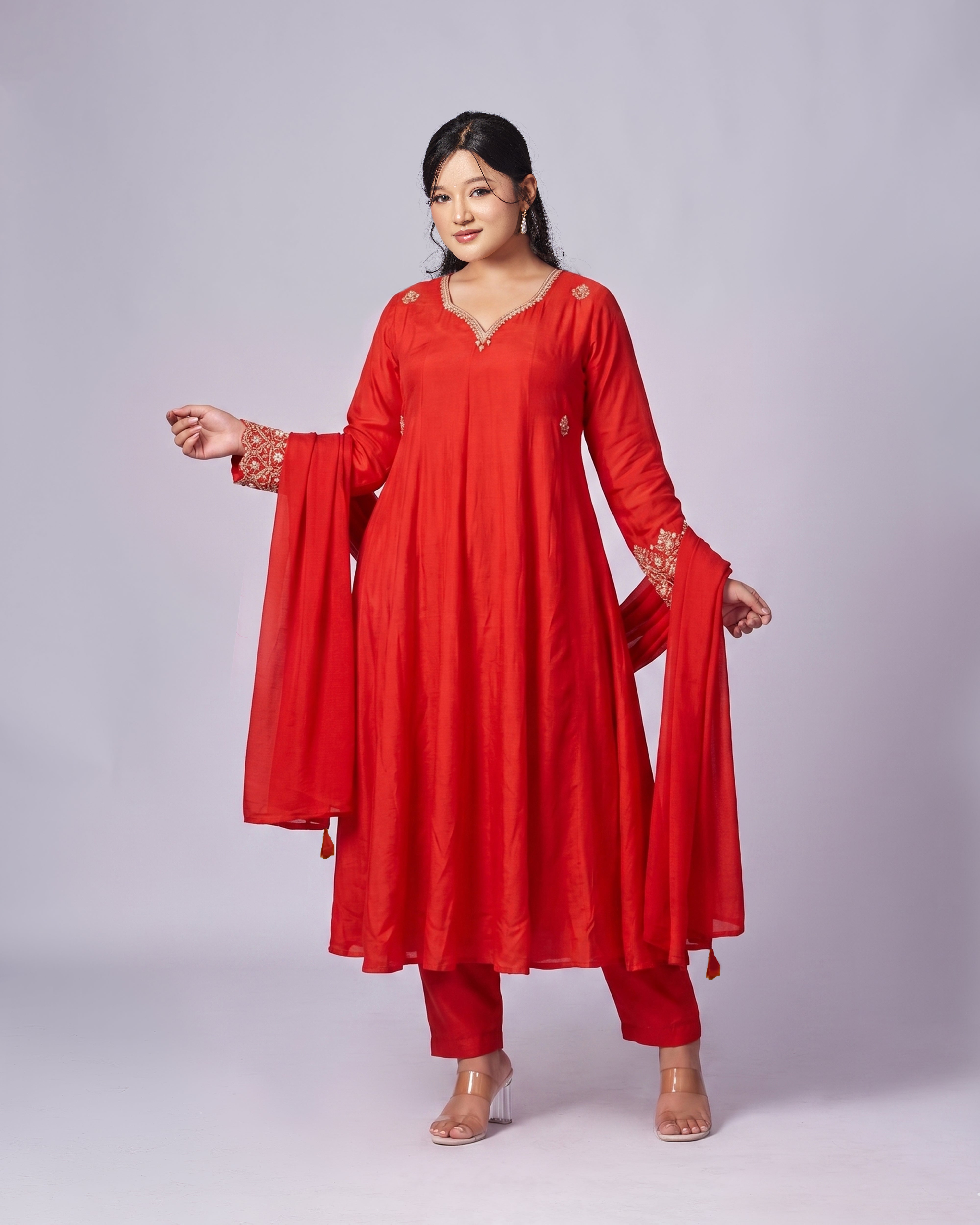 Woman wearing a red traditional outfit with a plain background