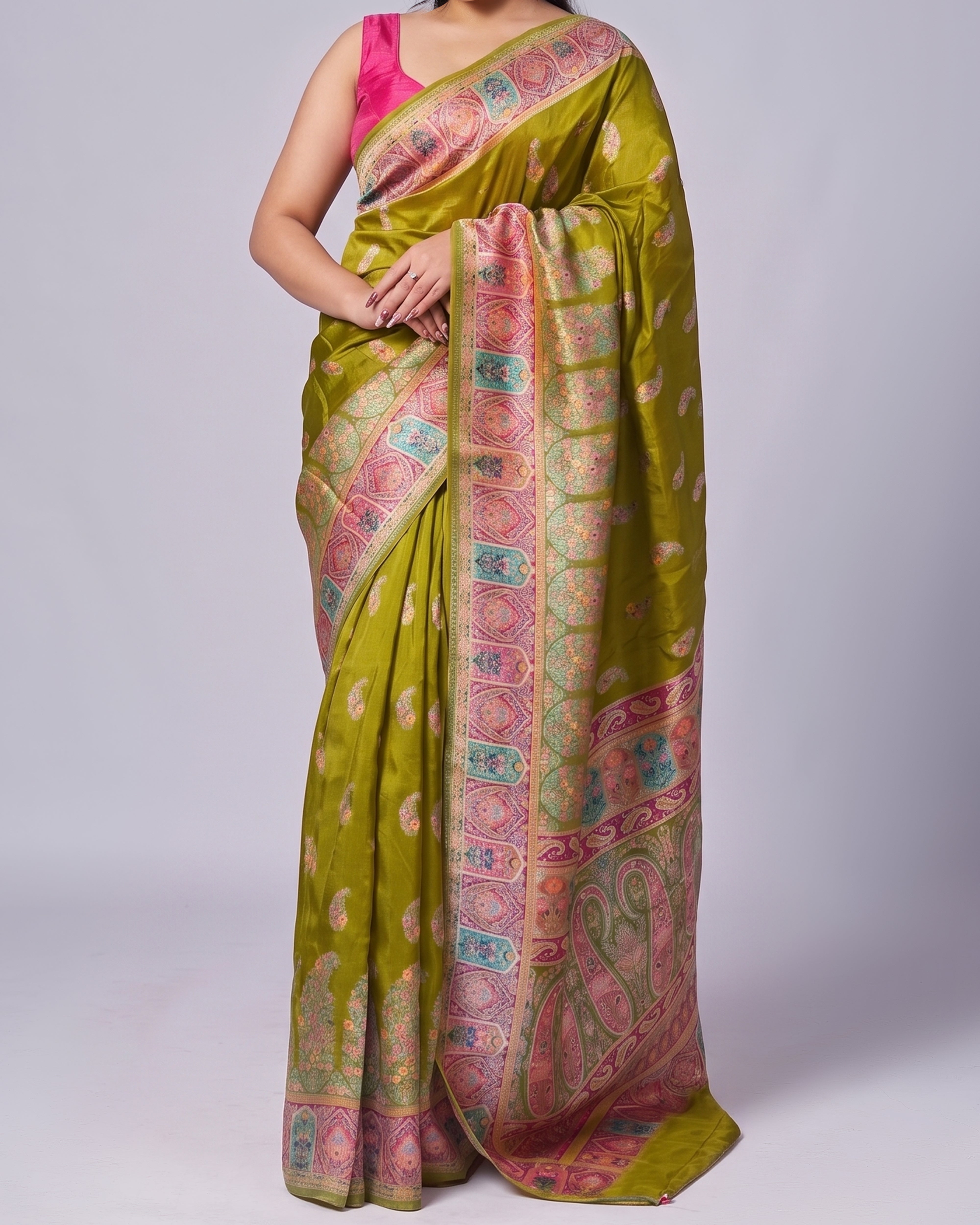 Green saree with pink and multicolor border on a white background