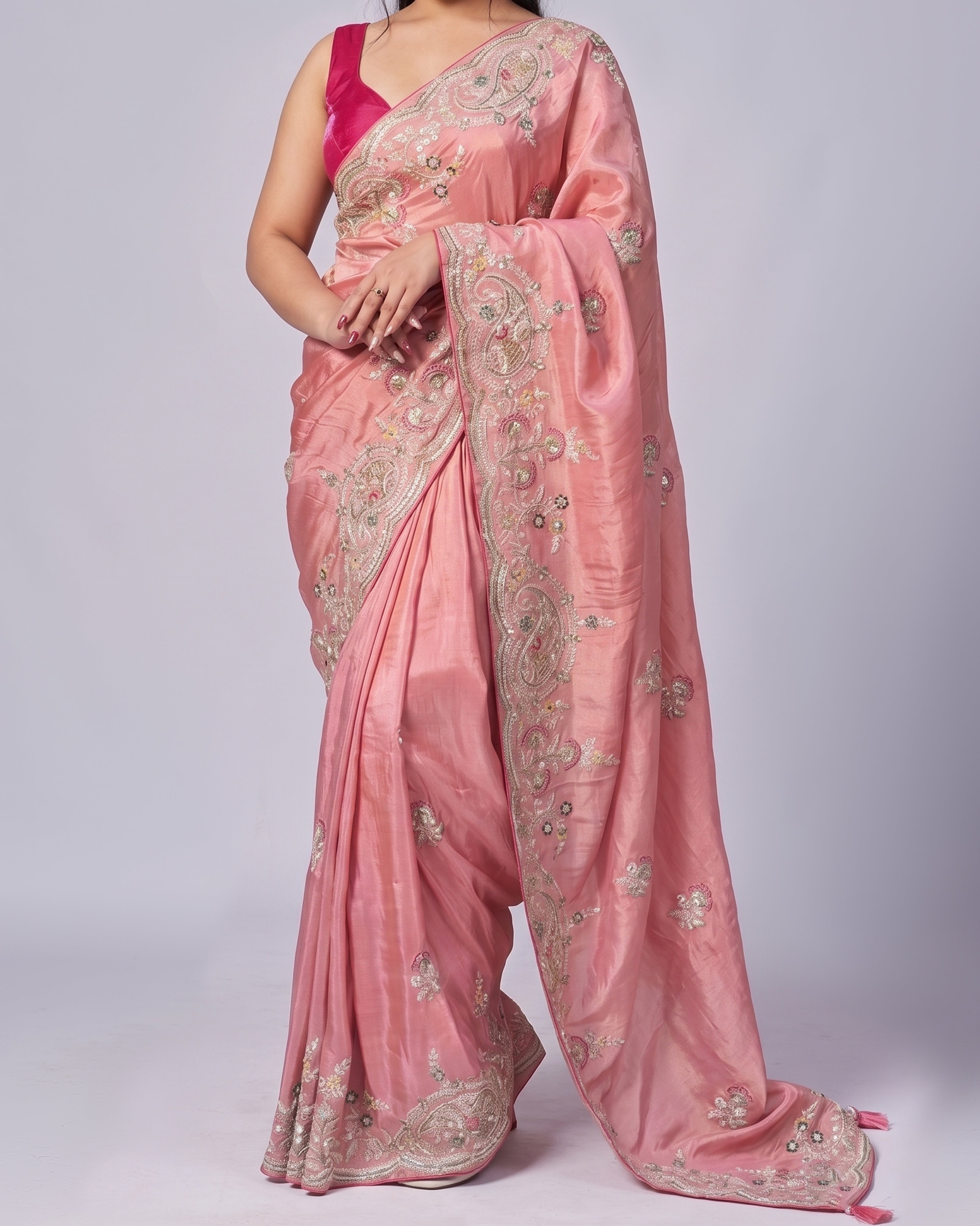 Pink saree with intricate designs on a white background
