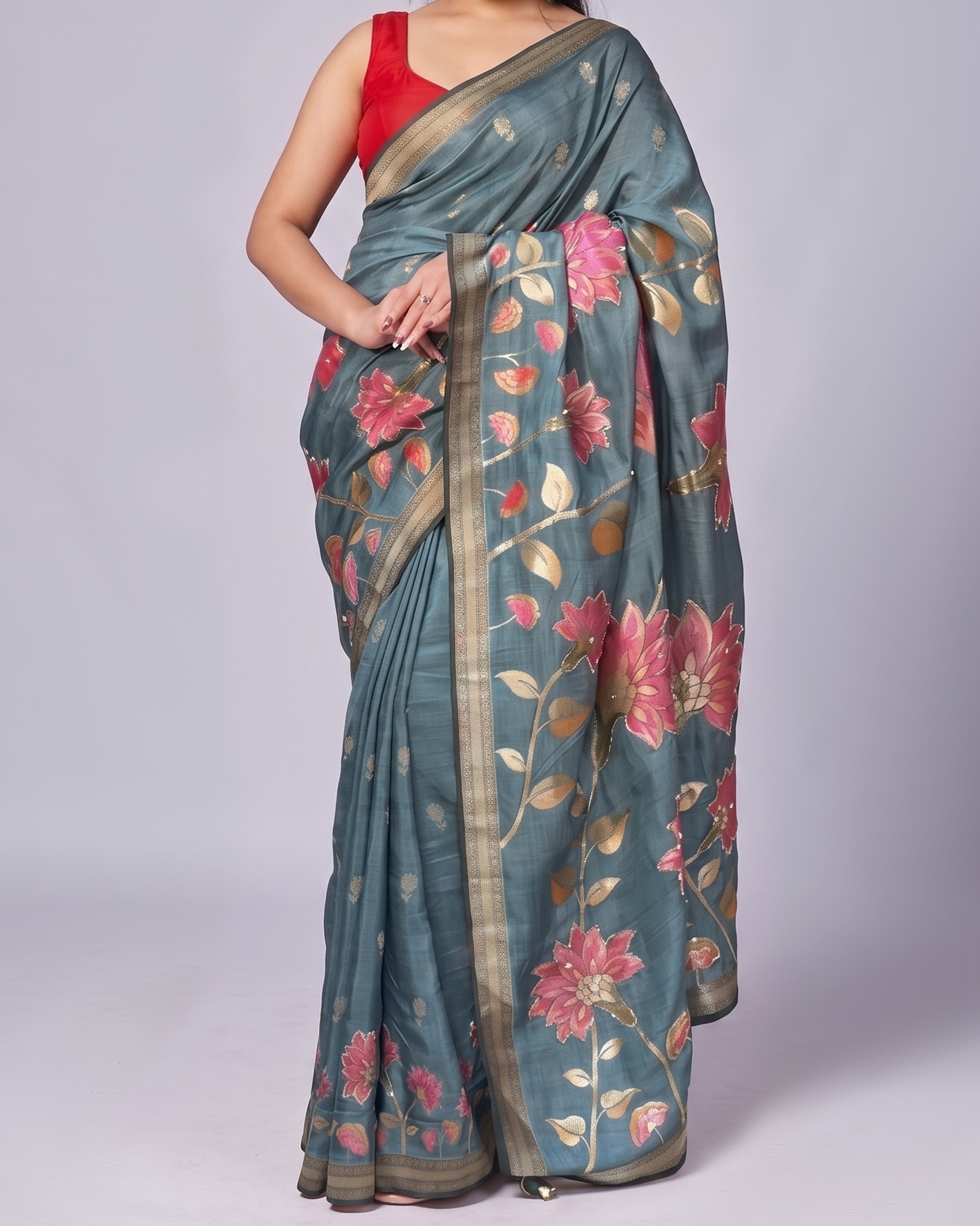 Woman wearing a floral saree with a red blouse on a white background