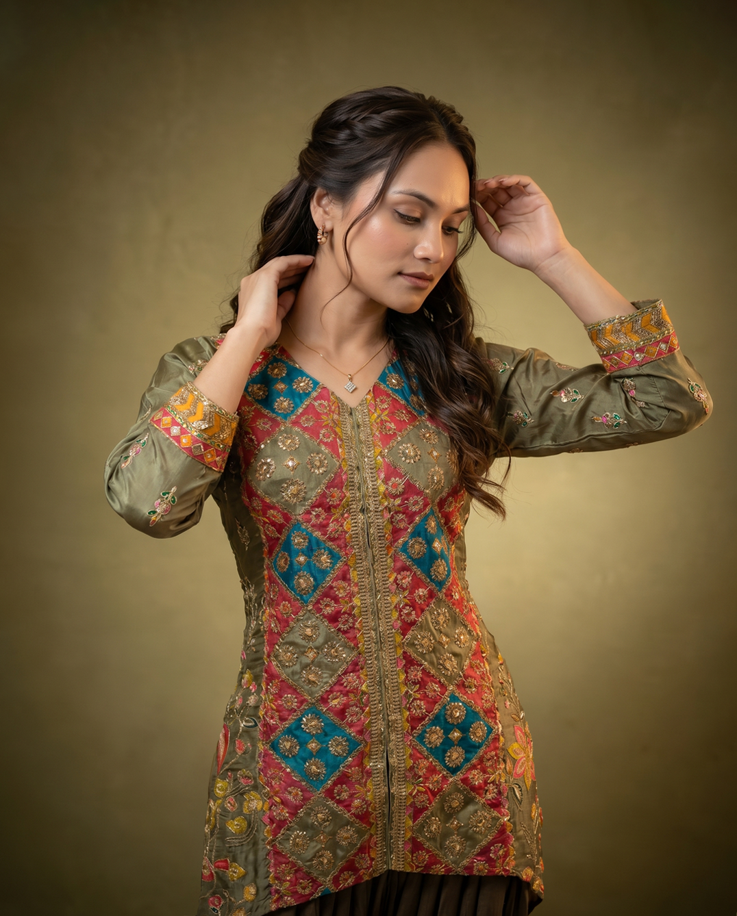Woman wearing a traditional embroidered outfit against a brown background