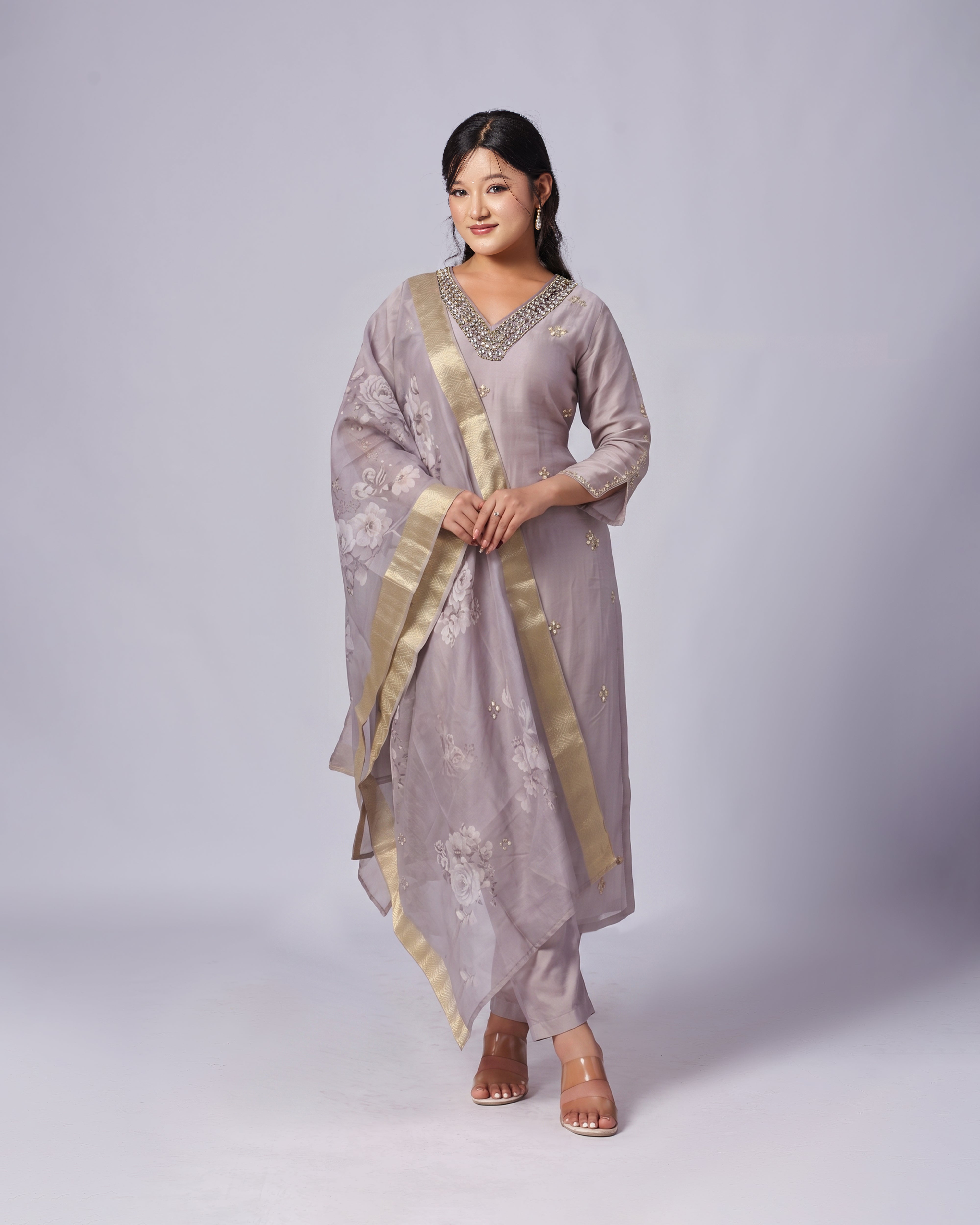 Woman wearing a traditional outfit with a plain background