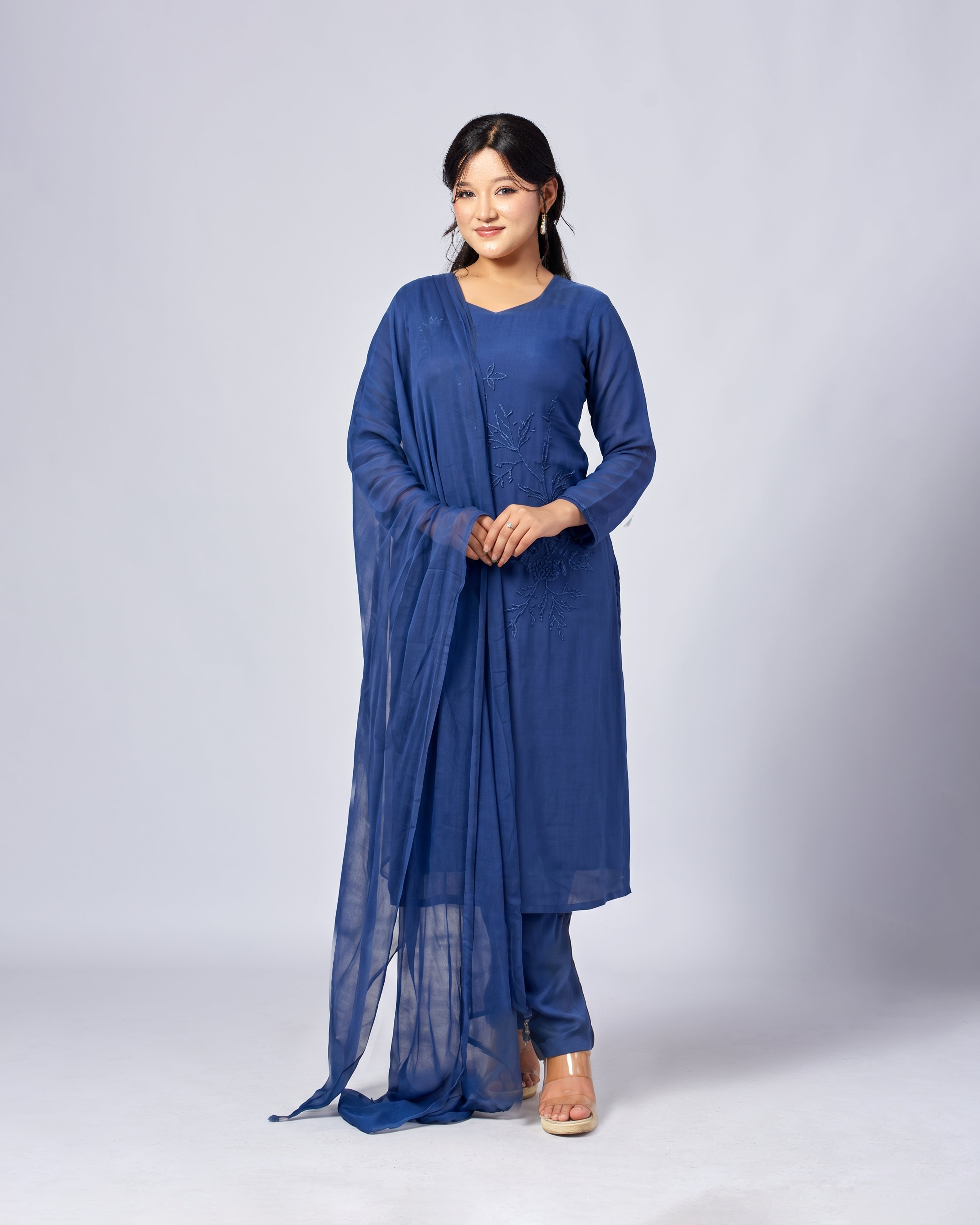 Woman wearing a blue traditional outfit on a white background