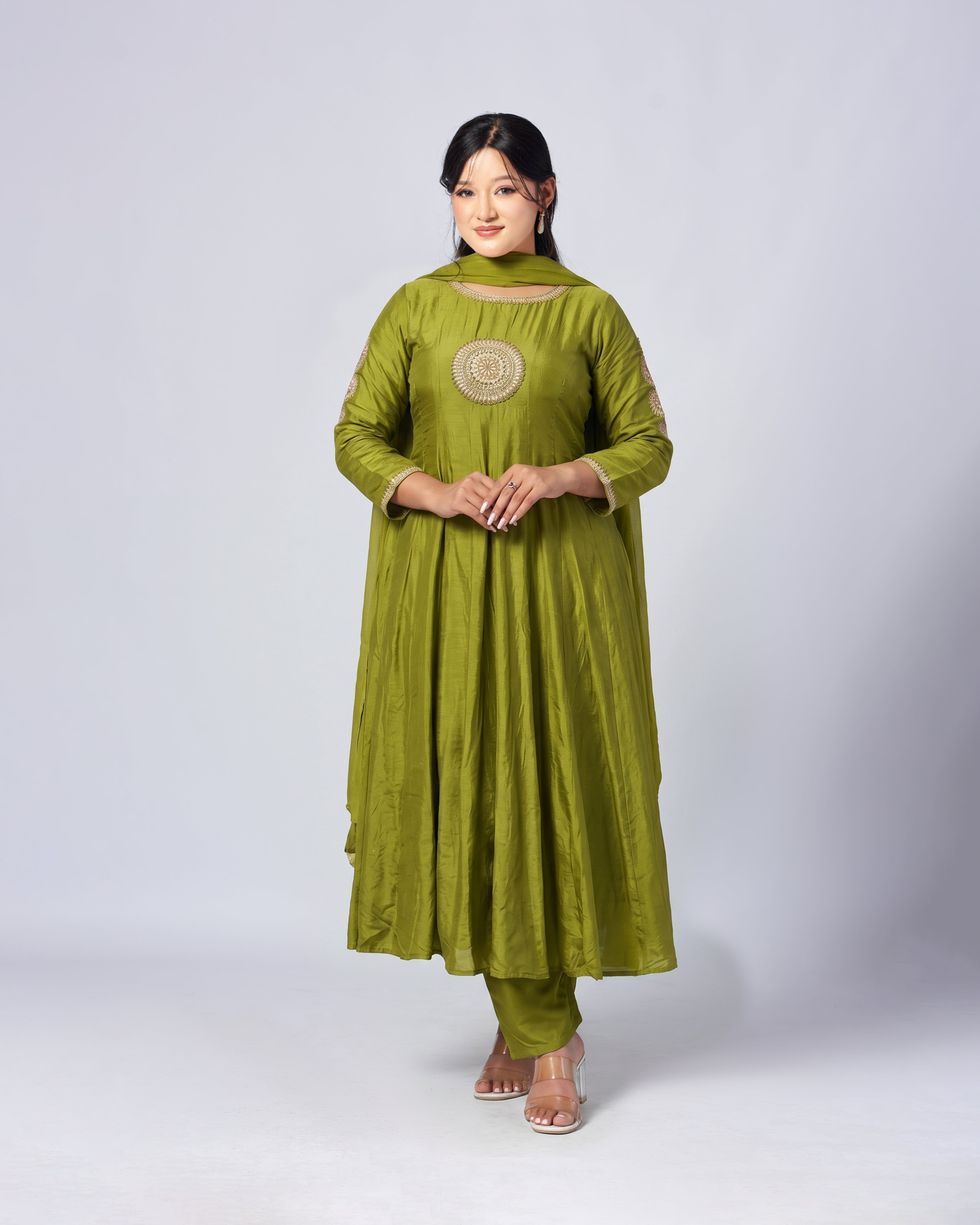 Woman wearing a green traditional outfit on a white background