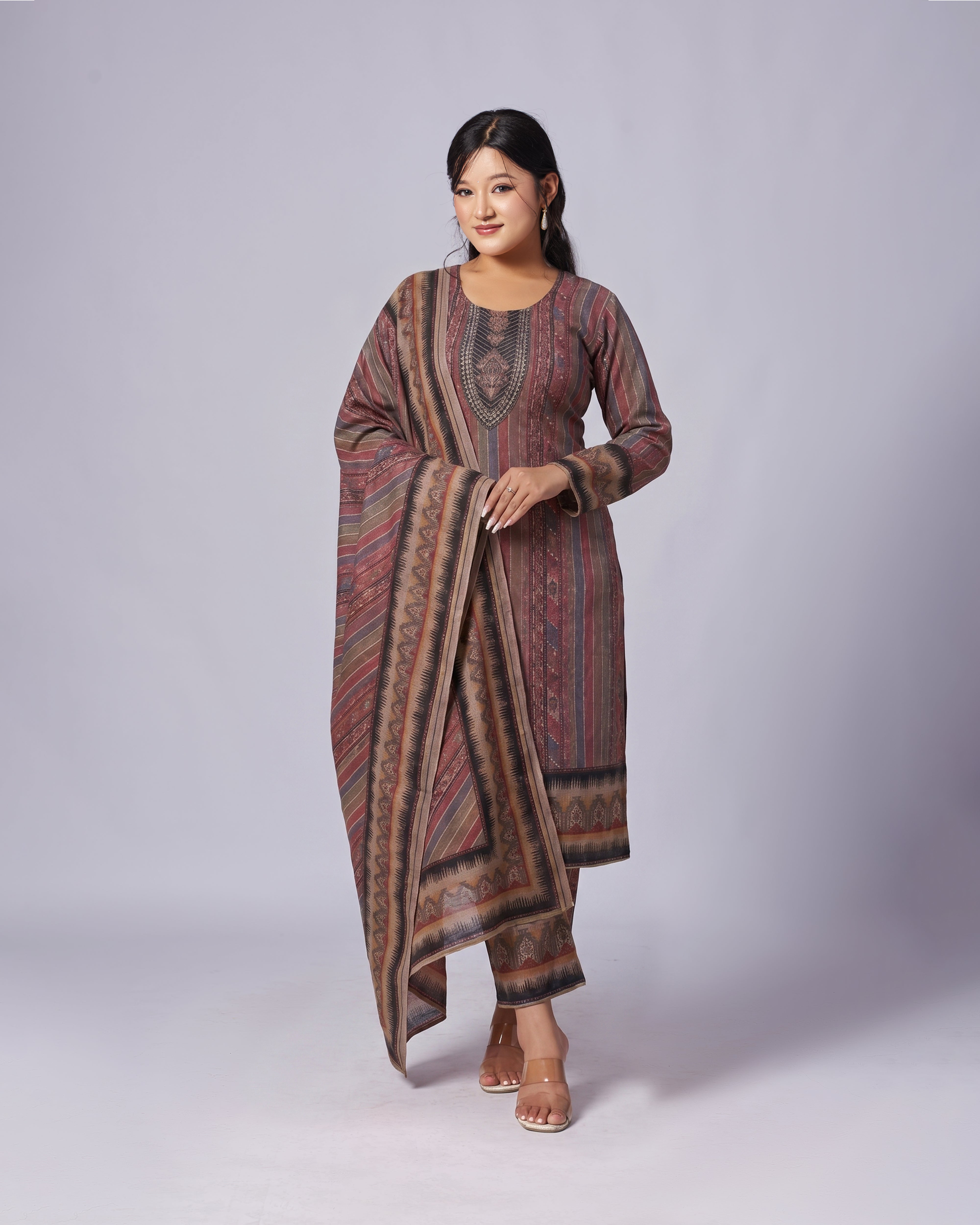 Woman wearing a patterned dress on a plain background