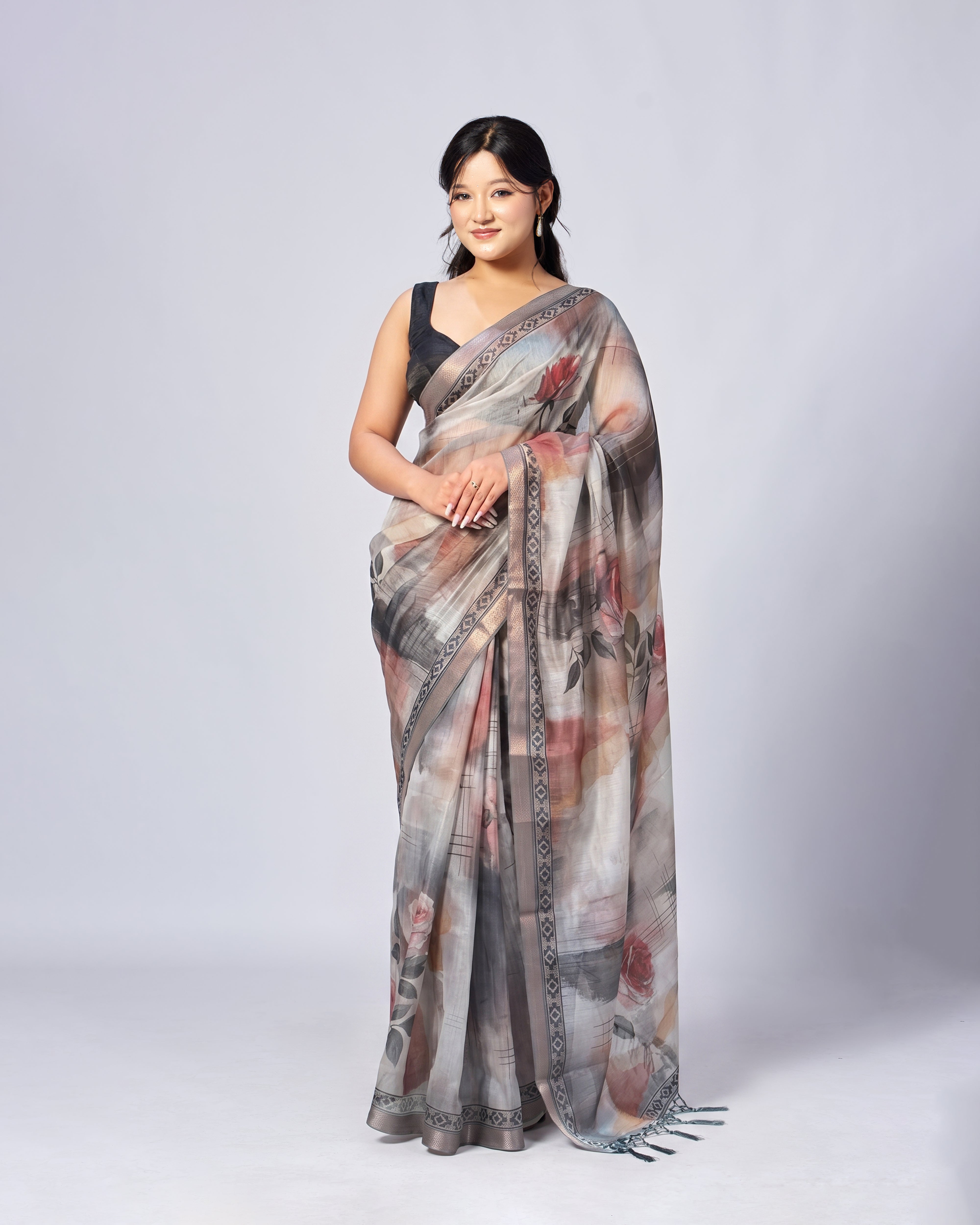 Woman wearing a floral saree on a white background