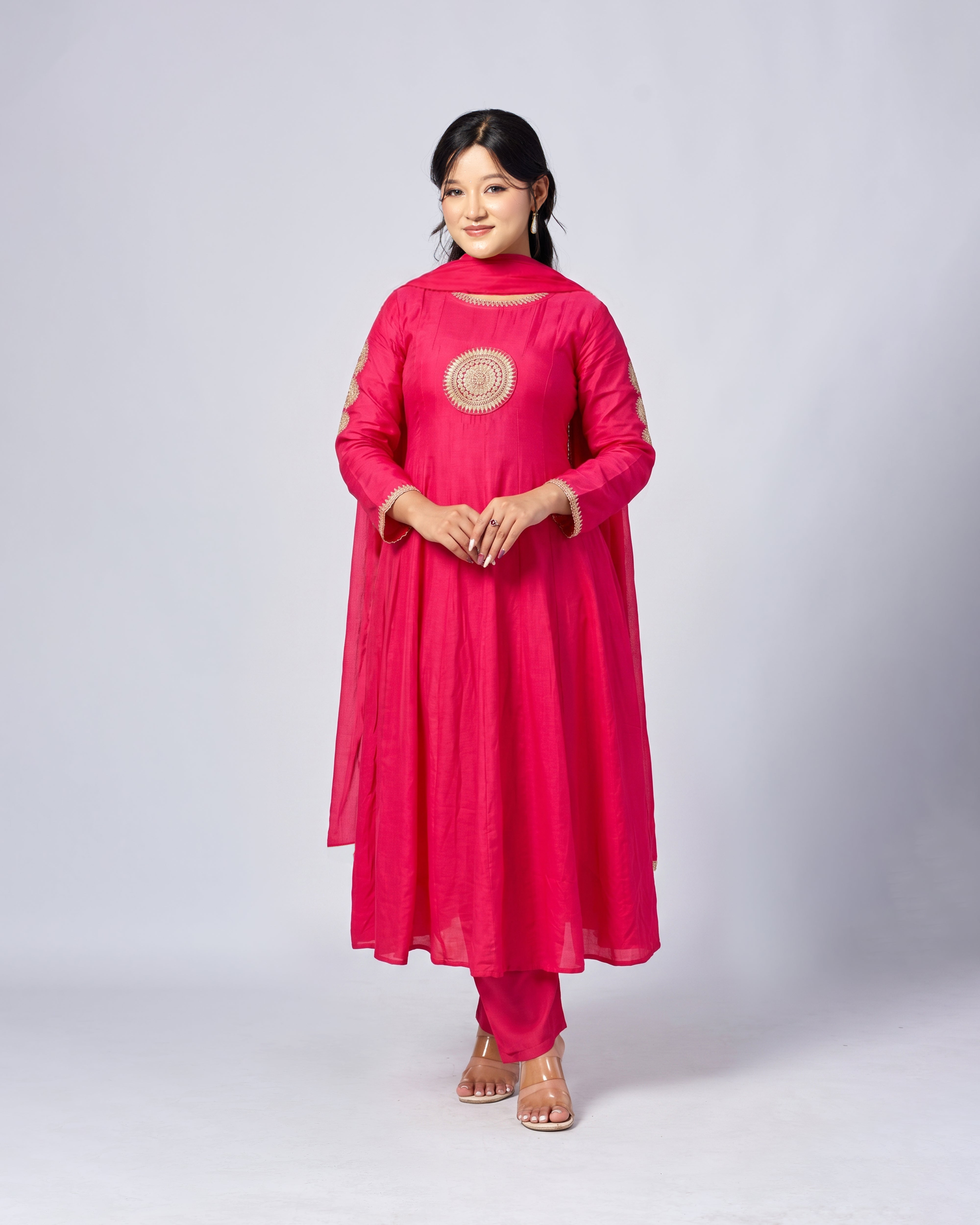 Woman wearing a pink traditional outfit with a white background