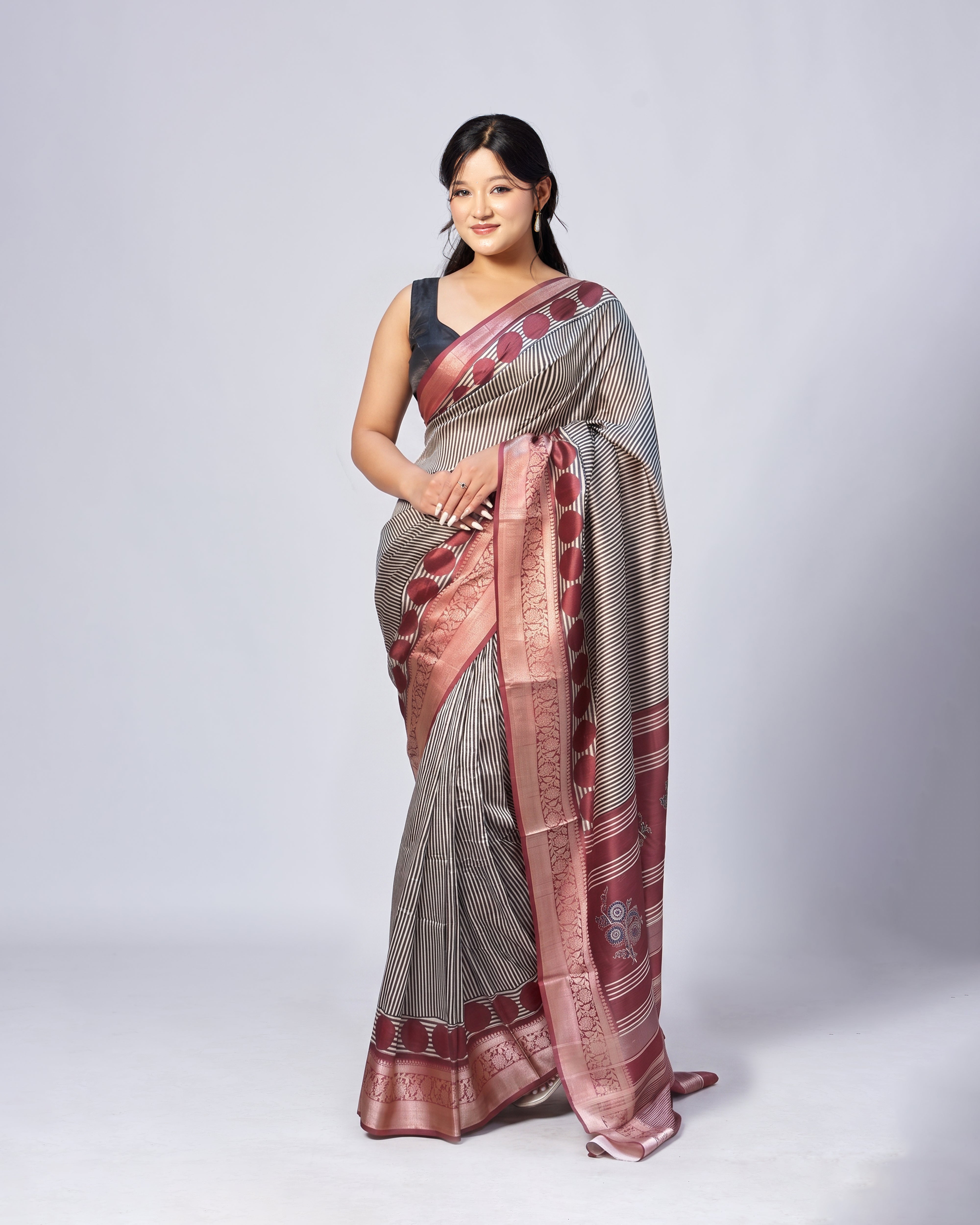Woman wearing a traditional saree with a white background
